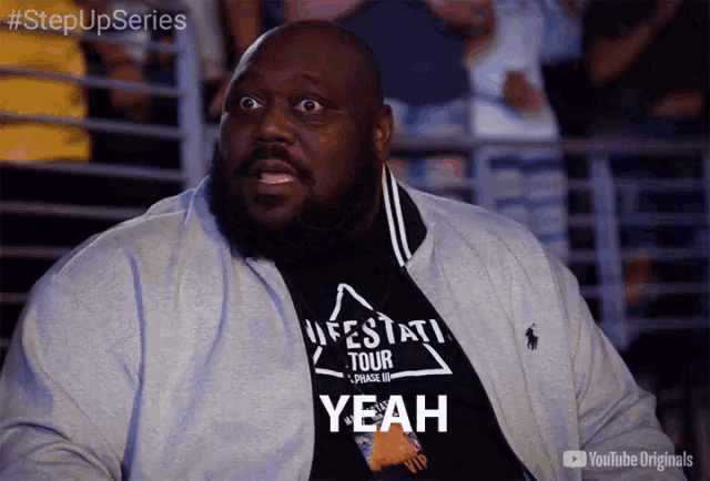 a man wearing a black shirt that says yeah on it