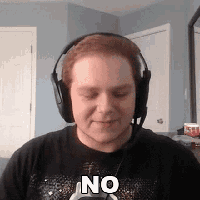 a man wearing headphones and a shirt that says no on it