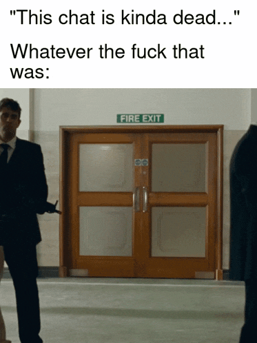a man in a suit and tie stands in front of a fire exit