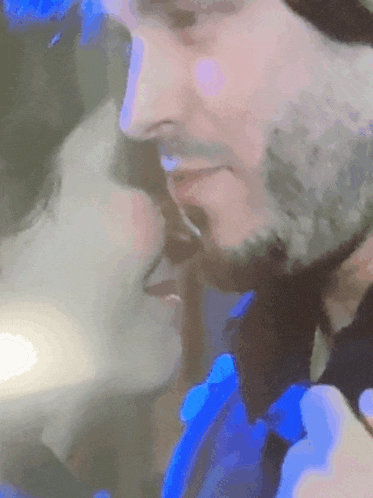 a man and a woman are kissing in a blurry photo