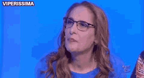 a woman wearing glasses is making a funny face and says ma chi sei ?