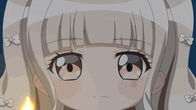 a close up of a girl 's face with a candle in her hand