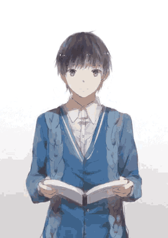 a young boy in a blue sweater is reading a book