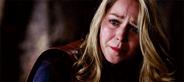 a close up of a woman 's face with a tear running down her face .