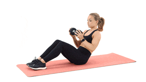 a woman is sitting on a yoga mat with a dumbbell in her hand