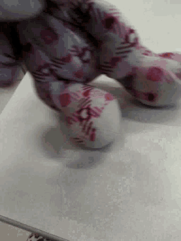 a close up of a person 's feet in a pair of pink and white socks .