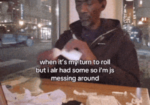 a man sits at a table with a bunch of tissues and says when it 's my turn to roll but