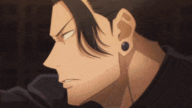 a close up of a man 's face with a black shirt and earrings