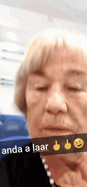 a close up of an elderly woman 's face with the words anda a laar on the bottom
