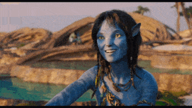 a woman with a blue face and yellow eyes smiles
