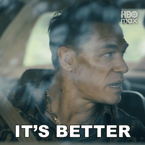 a man sitting in a car with the words " it 's better " above him