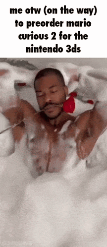 a man is laying in a bathtub holding a rose in his mouth .