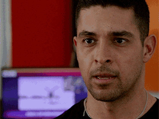 a close up of a man 's face in front of a computer screen