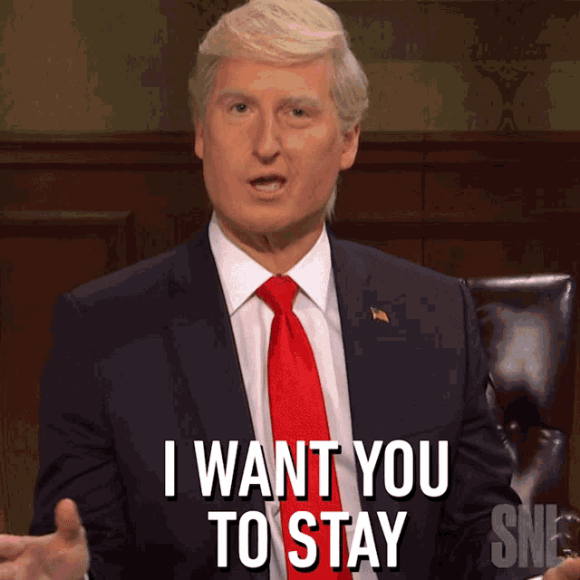 a man in a suit and red tie says i want you to stay