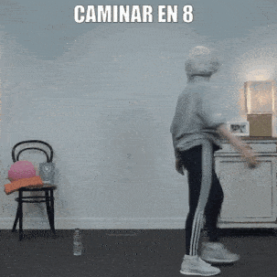 a woman is walking in a living room with the words caminar en 8 above her
