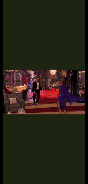 a man and woman are dancing in a room with a painting on the wall