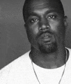 a man with a beard is wearing a white shirt and a necklace .