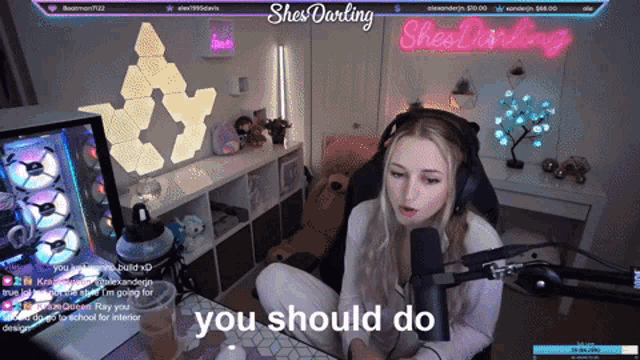 a woman sitting in front of a microphone with the words " you should do " on the bottom