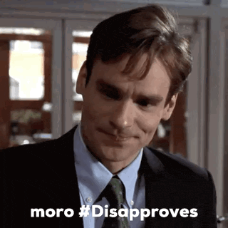 a man in a suit and tie is smiling with the words moro #disapproves below him