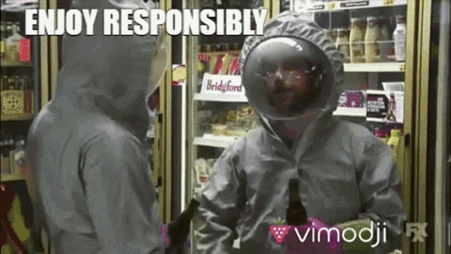 a man in a hazmat suit is standing next to another man in a fridge with the caption enjoy responsibly