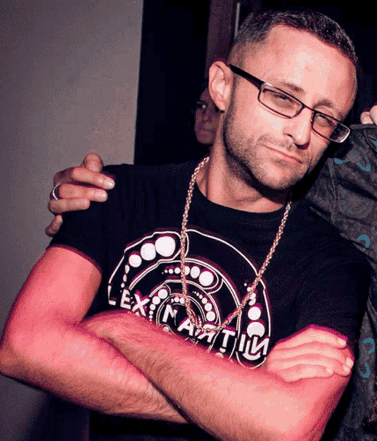 a man wearing glasses and a shirt that says lex nautica