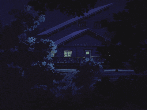 a house with a sign that says ' a ' on it is lit up at night