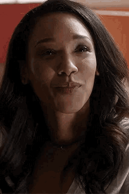 a close up of a woman 's face with her mouth open and her eyes closed .