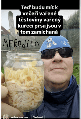 a man holding a jar of food with a spoon in it