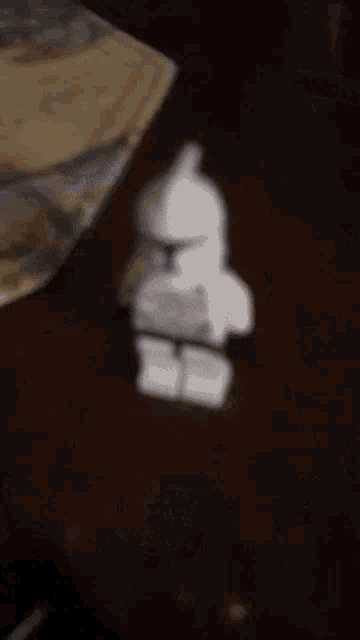 a blurred image of a person cutting a piece of food
