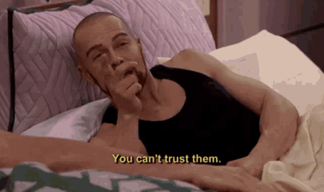 a man laying in bed with the words " you can 't trust them " on the bottom