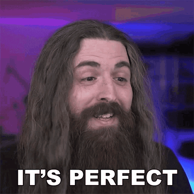 a man with long hair and a beard has the words it 's perfect on his face