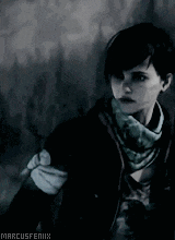 a woman with short hair is wearing a scarf around her neck and a black jacket .