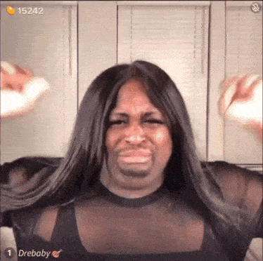 a woman with long hair is making a funny face while wearing a black shirt .