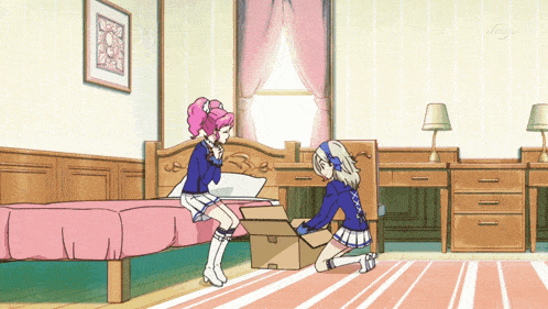two girls are kneeling down in a bedroom with a box on the floor