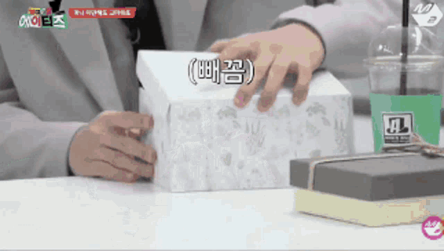 a person is holding a box that has a foreign language on it