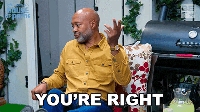 a man in a yellow shirt is sitting in front of a grill and says " you 're right " .