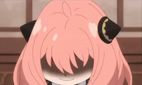 a girl with pink hair is smiling with her eyes closed and a cat ear .