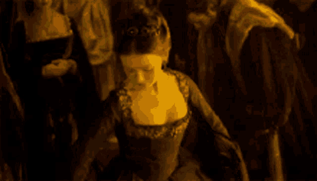 a woman in a black dress is standing in a crowd
