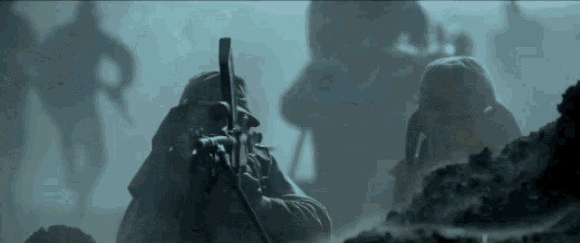 a soldier in a gas mask holds a rifle