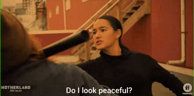 a woman talking to another woman with the words do i look peaceful on the bottom