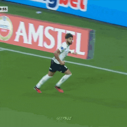 a soccer player is dancing on the field in front of a banner that says faz