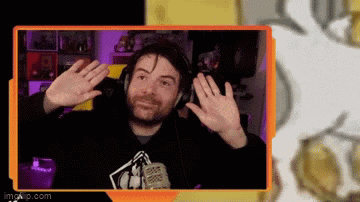 a man wearing headphones and a microphone is waving his hands in front of a screen .