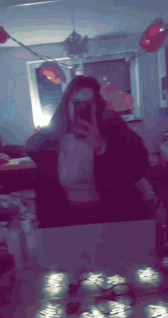 a woman is taking a selfie in front of a mirror