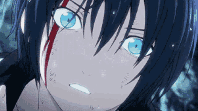 a close up of a person 's face with blue eyes and blood on his face .