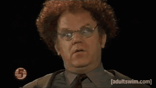 a man with curly hair and glasses is looking at the camera .