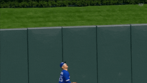 a baseball player in a blue jays uniform is running