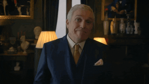 a man in a suit is holding a red card