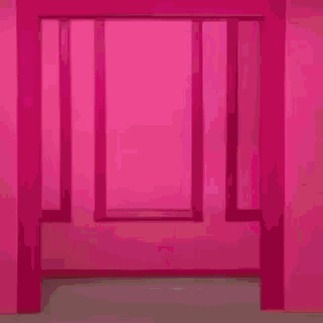 a woman with blonde hair is standing in front of a pink wall wearing a yellow shirt and a plaid jacket .