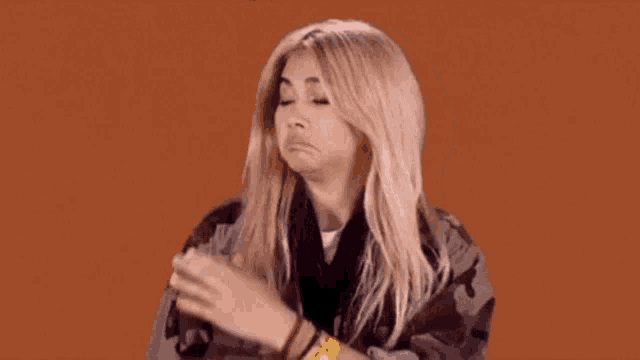 a woman is making a funny face while wearing a wristband that says ' a ' on it