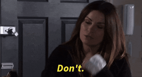 a woman is standing in front of a door and says do n't